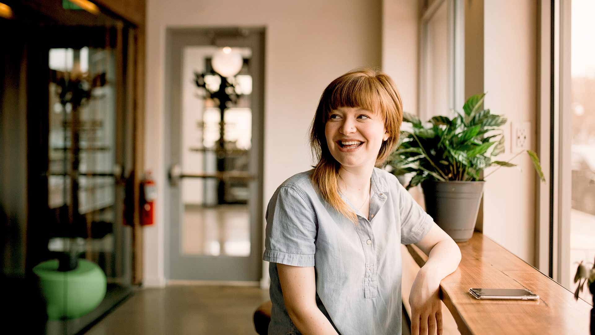 Frau am Tisch mit Handy